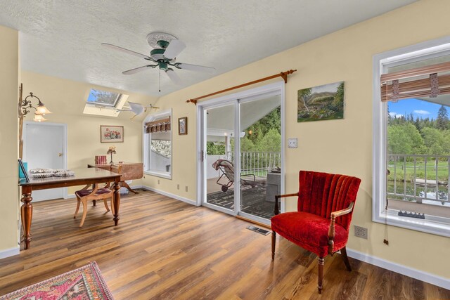 2443 Flowery Trail Rd, Usk, WA 99180 - sitting room featuring a skylight, wood finished floors, healthy amount of natural light, a ceiling fan, and a textured ceiling