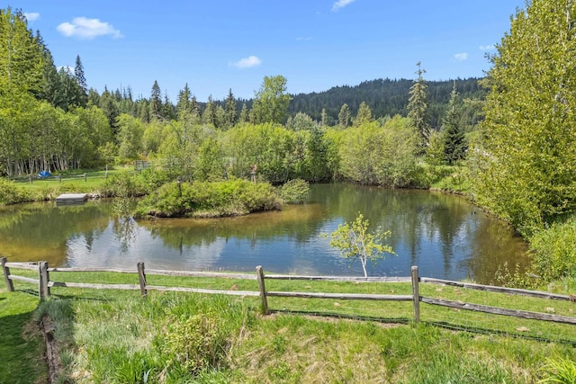 2443 Flowery Trail Rd, Usk, WA 99180 - water view featuring fence and a heavily wooded area