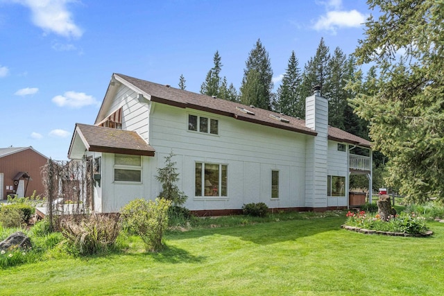 2443 Flowery Trail Rd, Usk, WA 99180 - rear view of house with a chimney, a yard, and a balcony