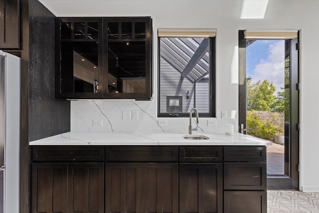 2503 S Thierman Ln, Spokane, WA 99223 - kitchen featuring a sink, light stone countertops, plenty of natural light, and backsplash