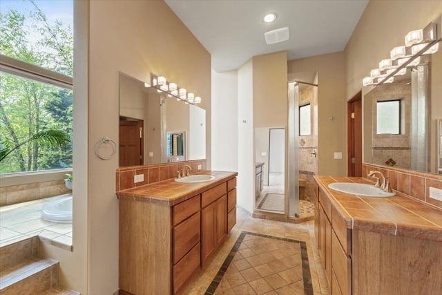 2503 S Thierman Ln, Spokane, WA 99223 - full bathroom with inlaid floor details, two vanities, plenty of natural light, and a stall shower