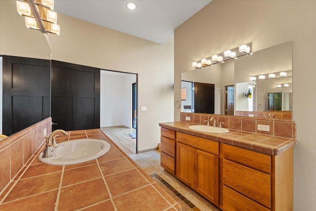 2503 S Thierman Ln, Spokane, WA 99223 - full bath featuring decorative backsplash, vanity, tile patterned flooring, baseboards, and a bath