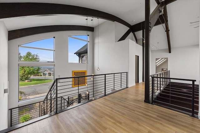 2503 S Thierman Ln, Spokane, WA 99223 - hallway featuring an upstairs landing, beam ceiling, wood finished floors, high vaulted ceiling, and arched walkways