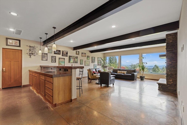 2503 S Thierman Ln, Spokane, WA 99223 - kitchen featuring a breakfast bar, open floor plan, a peninsula, a sink, and brown cabinetry