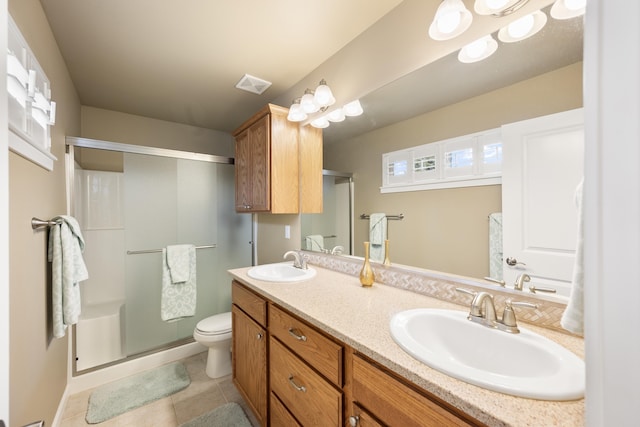 9016 N Sundance Dr, Spokane, WA 99208 - bathroom with a stall shower, double vanity, tile patterned flooring, and toilet