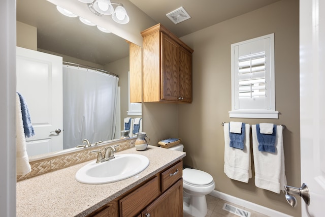 9016 N Sundance Dr, Spokane, WA 99208 - bathroom with toilet, tile patterned flooring, vanity, a shower with shower curtain, and baseboards