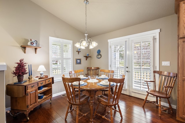 9016 N Sundance Dr, Spokane, WA 99208 - dining area with lofted ceiling, a chandelier, dark wood-style floors, and baseboards