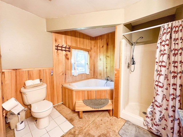 bathroom with wood walls, toilet, a shower stall, a garden tub, and tile patterned flooring