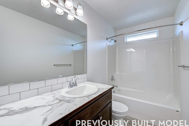 18806 E Riverside Ct, Spokane Valley, WA 99016 - full bath featuring toilet, shower / bath combination, vanity, and decorative backsplash