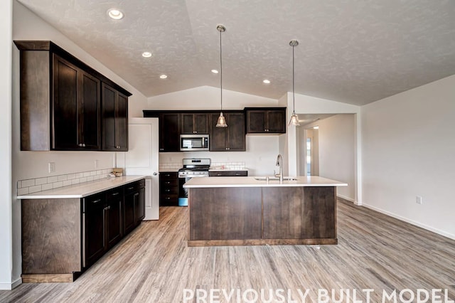 18806 E Riverside Ct, Spokane Valley, WA 99016 - kitchen with appliances with stainless steel finishes, a sink, light wood finished floors, lofted ceiling, and dark brown cabinets