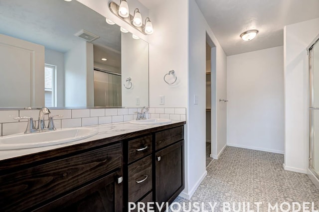 18806 E Riverside Ct, Spokane Valley, WA 99016 - full bathroom featuring a stall shower, double vanity, baseboards, and a spacious closet