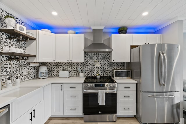305 S Liberty Lake Rd Unit 8, Liberty Lake, WA 99019 - kitchen featuring appliances with stainless steel finishes, open shelves, wall chimney range hood, ornamental molding, and white cabinets