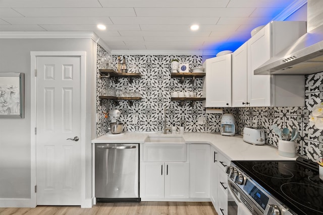 305 S Liberty Lake Rd Unit 8, Liberty Lake, WA 99019 - kitchen featuring appliances with stainless steel finishes, wall chimney exhaust hood, open shelves, ornamental molding, and white cabinets