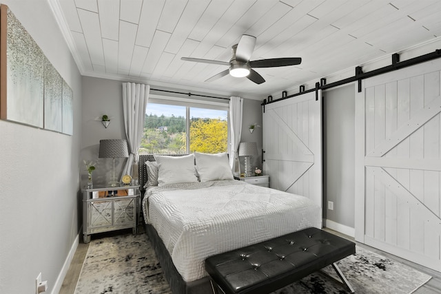305 S Liberty Lake Rd Unit 8, Liberty Lake, WA 99019 - bedroom with a barn door, wood finished floors, ornamental molding, baseboards, and ceiling fan
