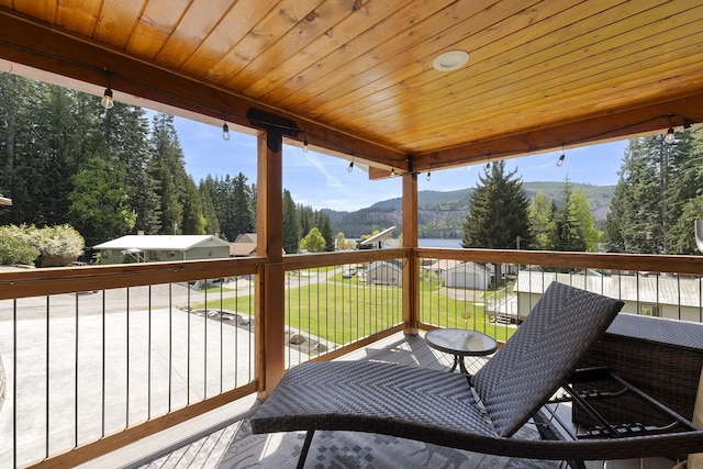 29955 N Isle View Rd, Spirit Lake, ID 83869 - wooden deck with a mountain view, a lawn, and a view of trees