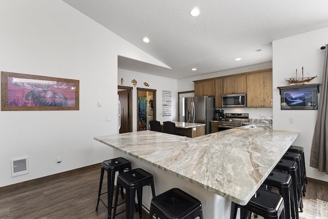 29955 N Isle View Rd, Spirit Lake, ID 83869 - kitchen featuring stainless steel appliances, a breakfast bar, a kitchen island, dark wood-style flooring, and recessed lighting