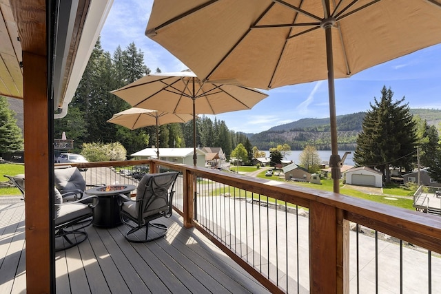 29955 N Isle View Rd, Spirit Lake, ID 83869 - deck featuring a fire pit and a water and mountain view