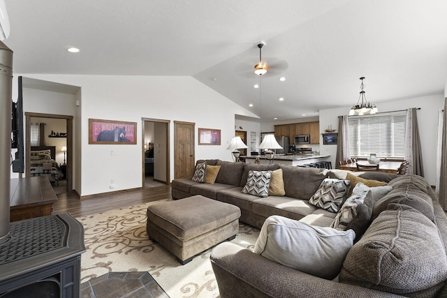 29955 N Isle View Rd, Spirit Lake, ID 83869 - living area with vaulted ceiling, recessed lighting, dark wood-type flooring, a ceiling fan, and a chandelier