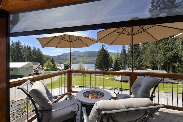 29955 N Isle View Rd, Spirit Lake, ID 83869 - wooden deck featuring a water and mountain view, a fire pit, and a yard