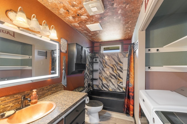 1503 E 3rd Ave, Post Falls, ID 83854 - bathroom with washer and dryer, tasteful backsplash, toilet, vanity, and bathing tub / shower combination