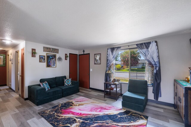 1503 E 3rd Ave, Post Falls, ID 83854 - living room with a textured ceiling, wood finished floors, and baseboards