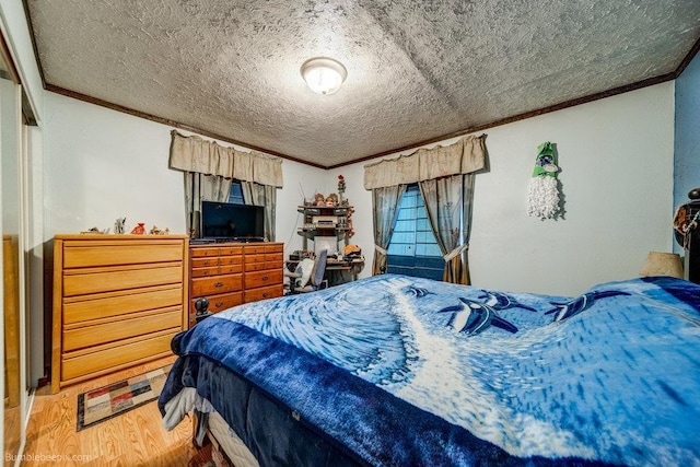 203 N Mcdonald Rd, Spokane, WA 99216 - bedroom with crown molding, wood finished floors, and a textured ceiling