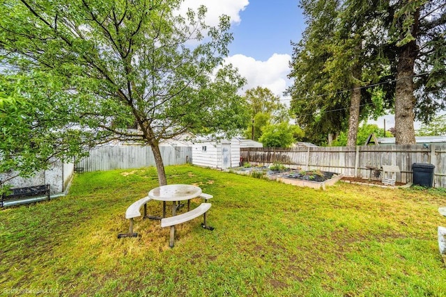 203 N Mcdonald Rd, Spokane, WA 99216 - view of yard featuring a vegetable garden, an outbuilding, and a storage shed
