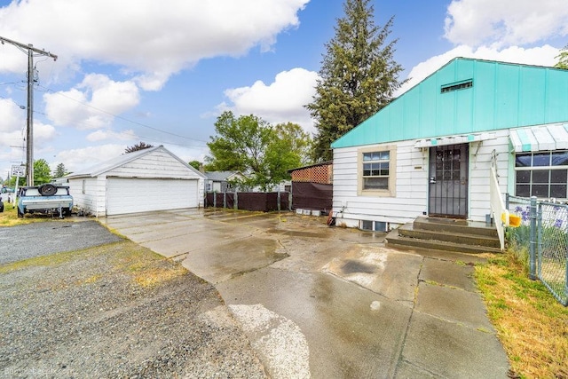 203 N Mcdonald Rd, Spokane, WA 99216 - view of front of house with a detached garage, fence, entry steps, an outbuilding, and board and batten siding