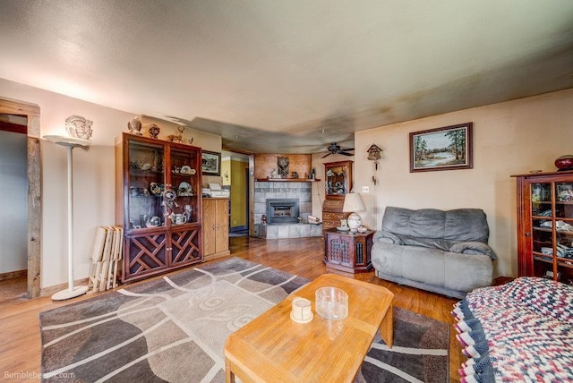 203 N Mcdonald Rd, Spokane, WA 99216 - living area featuring ceiling fan, a tiled fireplace, and wood finished floors