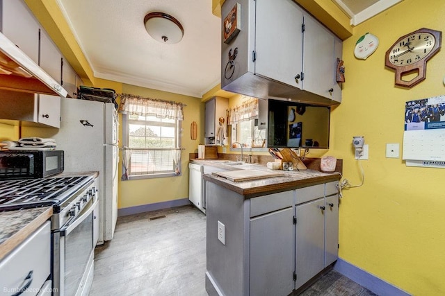 203 N Mcdonald Rd, Spokane, WA 99216 - kitchen featuring stainless steel gas range oven, black microwave, dishwasher, a sink, and baseboards