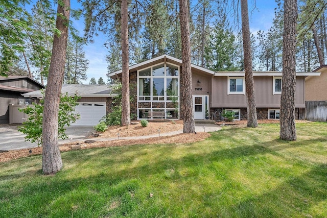 11010 E 28th Ave, Spokane, WA 99206 - view of front of house with a front yard, a garage, driveway, and stone siding