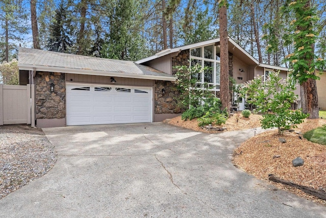 11010 E 28th Ave, Spokane, WA 99206 - mid-century modern home with stone siding, concrete driveway, and a garage