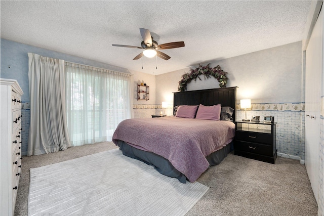 11010 E 28th Ave, Spokane, WA 99206 - bedroom featuring light carpet, a ceiling fan, a textured ceiling, and a wainscoted wall