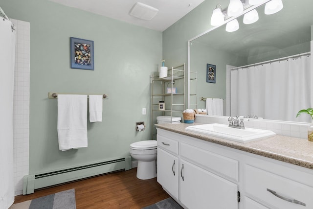 11010 E 28th Ave, Spokane, WA 99206 - bathroom featuring a baseboard radiator, vanity, toilet, wood finished floors, and a shower with curtain