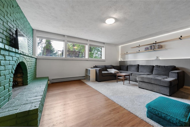 11010 E 28th Ave, Spokane, WA 99206 - living room with a baseboard heating unit, a textured ceiling, and wood finished floors