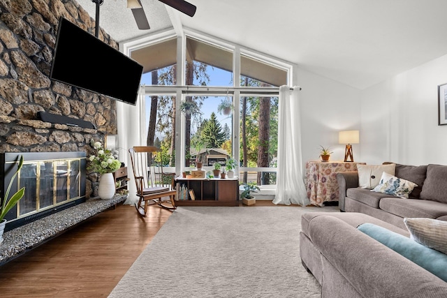 11010 E 28th Ave, Spokane, WA 99206 - living area with ceiling fan, vaulted ceiling, wood finished floors, and a fireplace