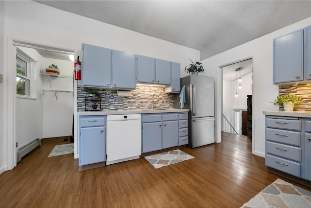 11010 E 28th Ave, Spokane, WA 99206 - kitchen featuring dishwasher, blue cabinets, freestanding refrigerator, a baseboard radiator, and a sink