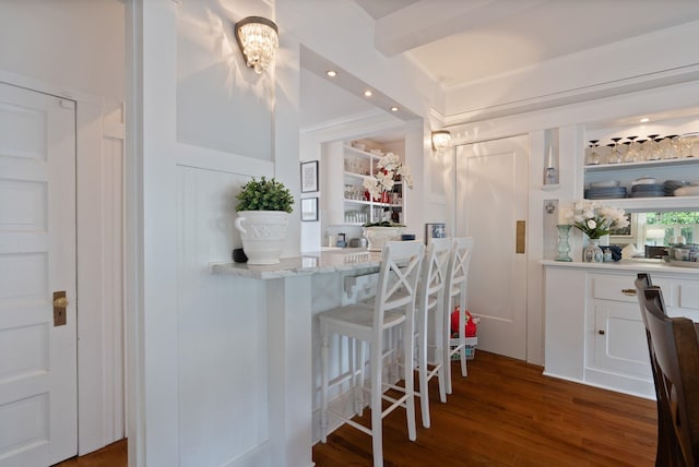 bar area featuring wood finished floors, crown molding, and recessed lighting