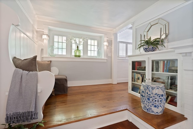 living area featuring wood finished floors and baseboards