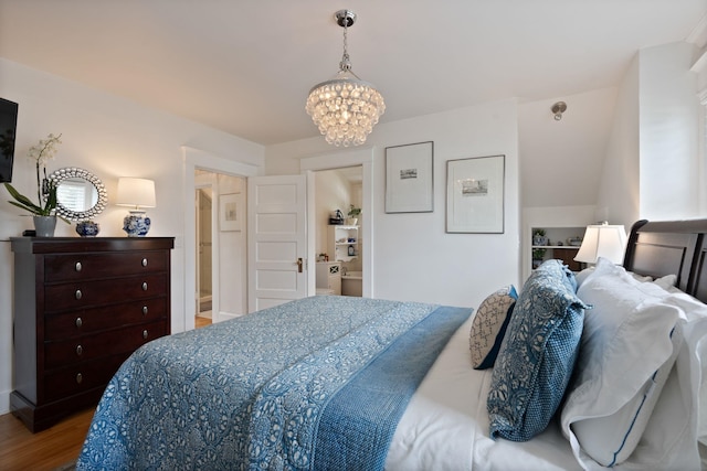 bedroom with wood finished floors and a chandelier