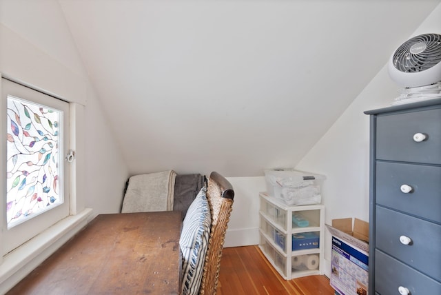 bedroom featuring lofted ceiling and wood finished floors