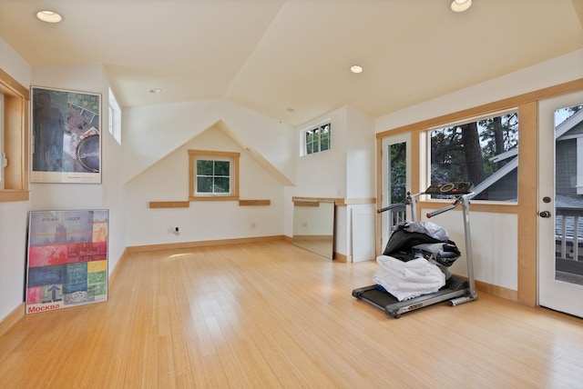 workout area featuring wood finished floors, baseboards, vaulted ceiling, and recessed lighting