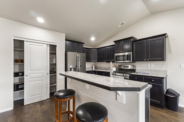 18924 E Fredrick Ave, Otis Orchards, WA 99027 - kitchen featuring appliances with stainless steel finishes, vaulted ceiling, dark wood-style flooring, light countertops, and recessed lighting