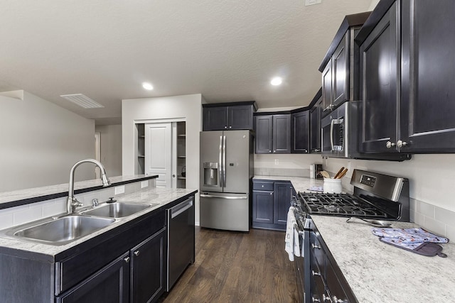 18924 E Fredrick Ave, Otis Orchards, WA 99027 - kitchen with appliances with stainless steel finishes, a sink, dark wood-style floors, dark cabinets, and recessed lighting