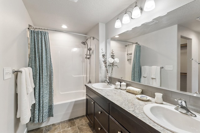 18924 E Fredrick Ave, Otis Orchards, WA 99027 - full bathroom featuring double vanity, shower / bath combo with shower curtain, a textured ceiling, a spacious closet, and recessed lighting