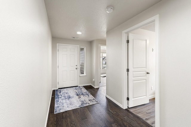 18924 E Fredrick Ave, Otis Orchards, WA 99027 - foyer entrance featuring dark wood-type flooring, baseboards, and a textured ceiling