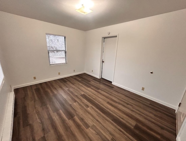 1618 N Lincoln St, Spokane, WA 99205 - spare room featuring dark wood-type flooring, baseboards, and a baseboard radiator