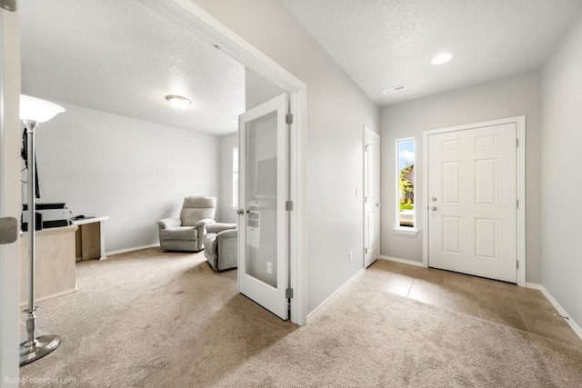 7919 W 55th Ave, Spokane, WA 99224 - tiled foyer entrance featuring carpet flooring, a textured ceiling, and baseboards
