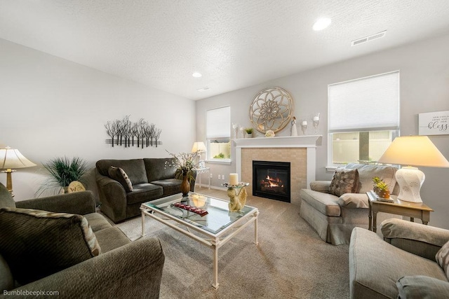 7919 W 55th Ave, Spokane, WA 99224 - living area featuring carpet, a tile fireplace, a textured ceiling, and recessed lighting