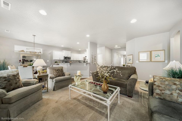 7919 W 55th Ave, Spokane, WA 99224 - living area with recessed lighting, baseboards, arched walkways, and light carpet